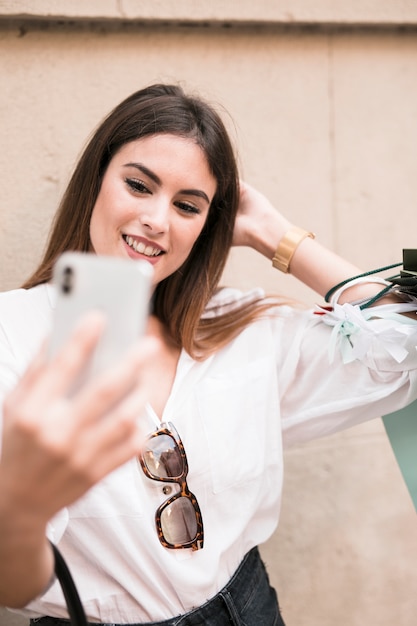 Chica de compras haciéndose un selfie