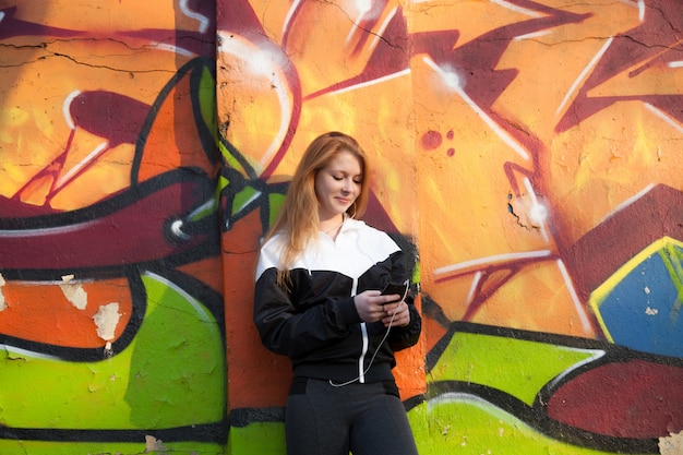 Chica deportista con un teléfono inteligente