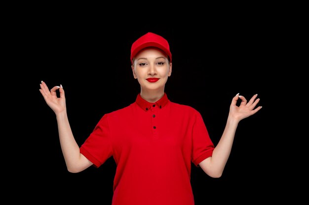 Chica de día de camisa roja mostrando gesto zen en una gorra roja con camisa con lápiz labial