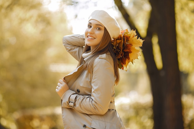 Chica elegante y con estilo en un parque de otoño