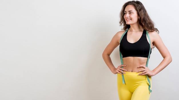 Chica fitness con cinta métrica