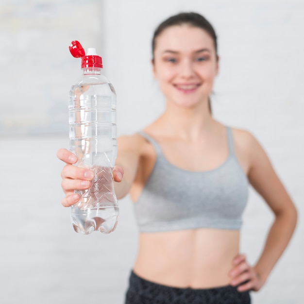 Chica fitness sosteniendo botella de agua