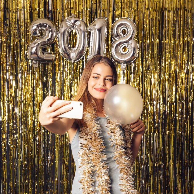 Chica haciendo un selfie en fiesta de año nuevo