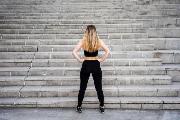 Chica joven delante de escaleras