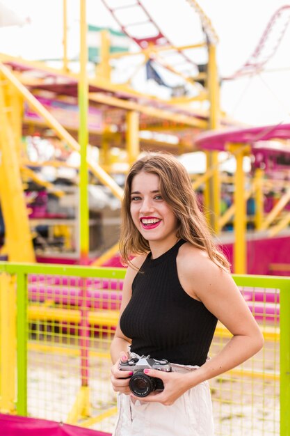 Chica joven divirtiéndose en el parque de atracciones