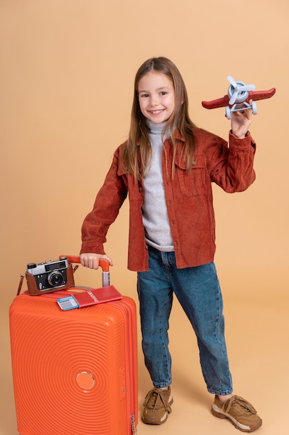 Chica joven lista para viajar de vacaciones con maleta