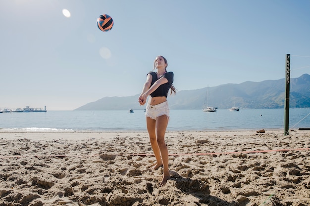 Chica jugando al voleibol de playa