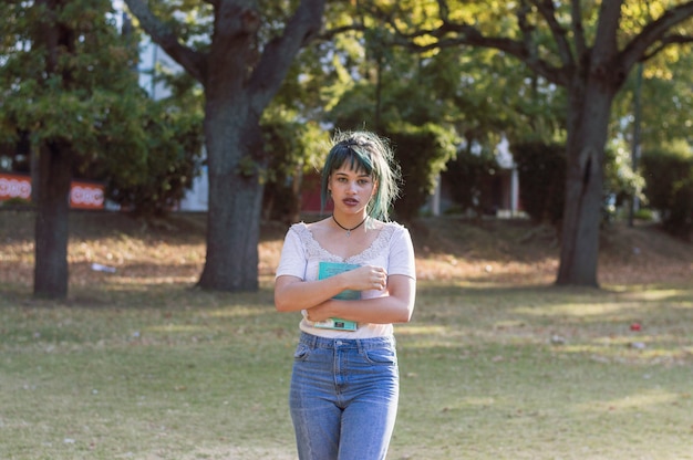 Foto gratuita chica con libro en el campus