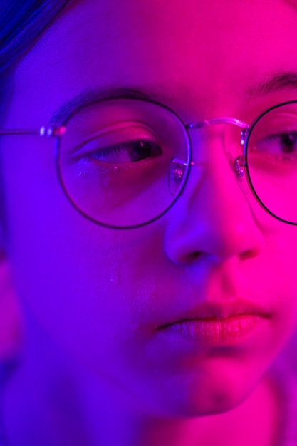 Foto gratuita chica linda con gafas llorando en la luz de neón cara de primer plano