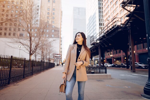 Chica de moda caminando en una ciudad de sping