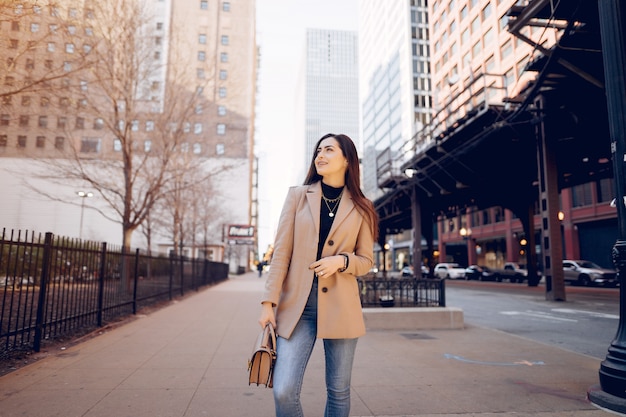 Chica de moda caminando en una ciudad de sping