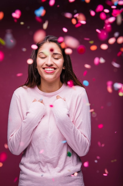 Foto gratuita chica morena sonriente con confeti