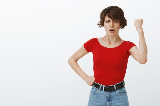 Chica de pelo corto posando en camiseta roja