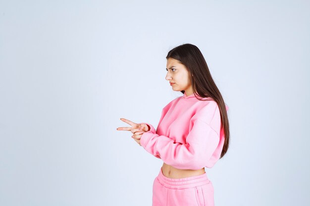 Chica en pijama rosa haciendo cara muy agresiva y enojada