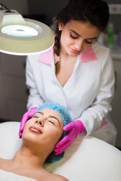 Chica recibiendo tratamiento facial en salón de belleza