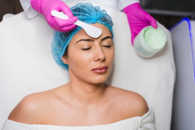 Chica recibiendo tratamiento facial en salón de belleza