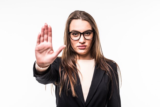 Chica en suite negra y gafas muestra señal de stop aislado en blanco