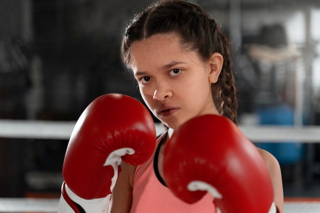 Foto gratuita chica de tiro medio aprendiendo boxeo