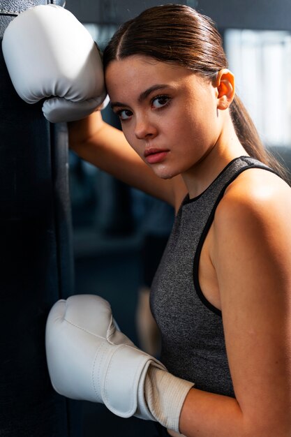 Chica de tiro medio aprendiendo boxeo