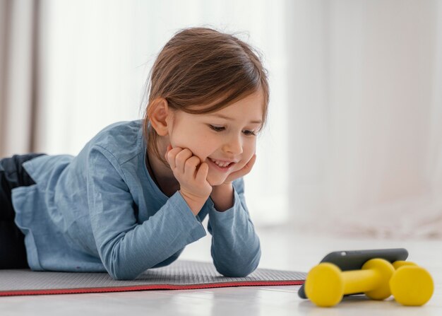 Chica de tiro medio mirando smartphone