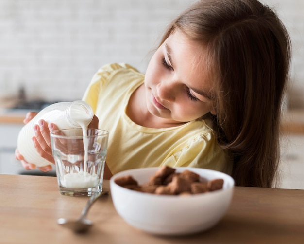 Foto gratuita chica de tiro medio vertiendo leche