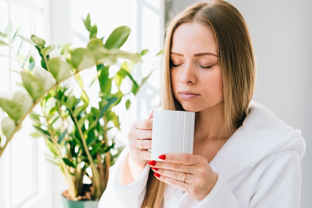 Chica tomándose un café en el baño