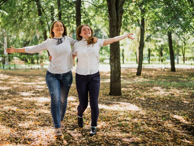 Chicas adolescentes caminando y abrazándose