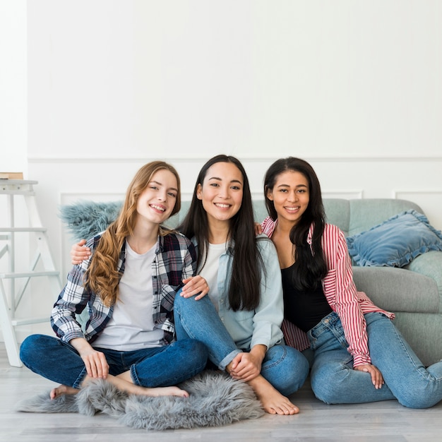 Chicas adolescentes posando sentado en el piso