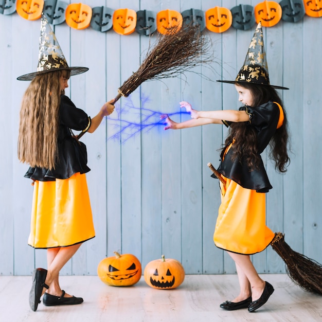 Chicas con disfraces de brujas lanzando hechizos