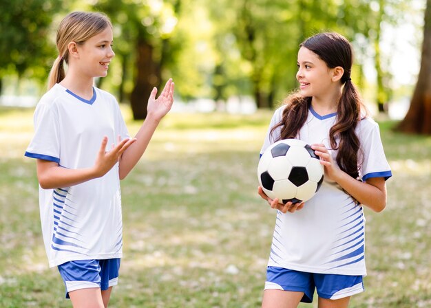 Chicas en equipo de fútbol hablando