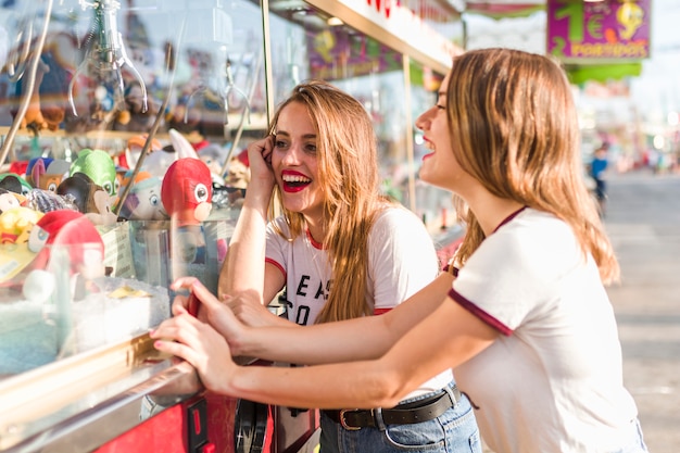 Chicas felices divirtiéndose en el parque de atracciones