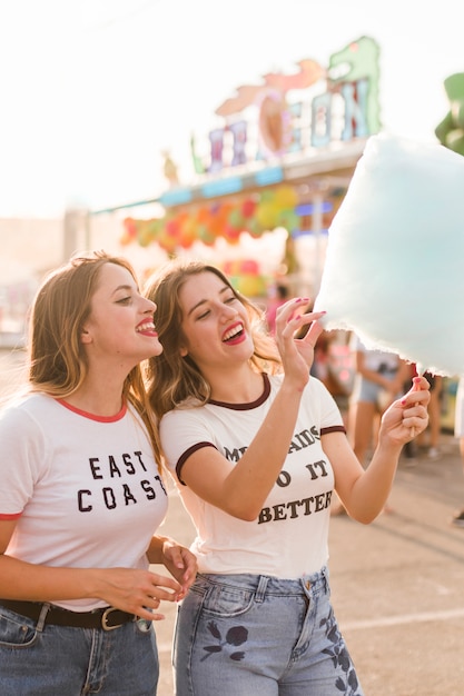 Chicas felices divirtiéndose en el parque de atracciones