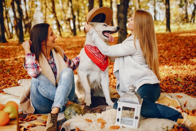 Chicas guapas se divierten en un parque de otoño