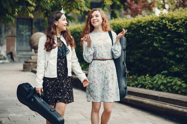 Chicas hermosas y románticas en un parque con un violín