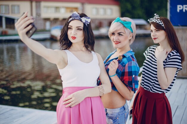 Chicas jóvenes posando para una autofoto con el mar de fondo