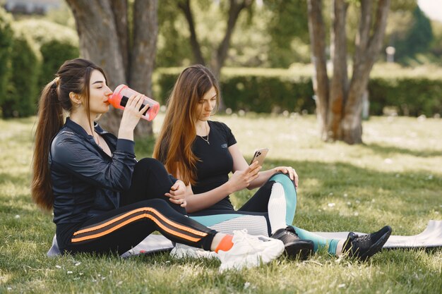 Chicas lindas haciendo yoga en un parque de verano