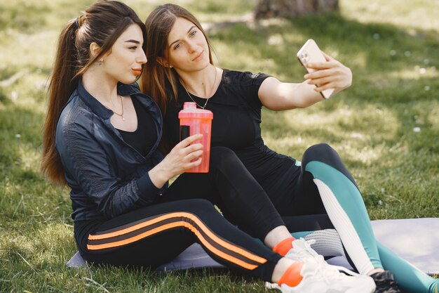 Chicas lindas haciendo yoga en un parque de verano