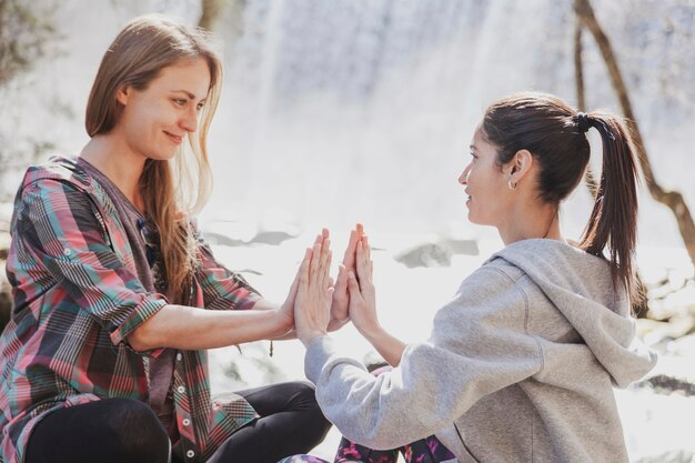 Chicas relajadas con las manos juntas