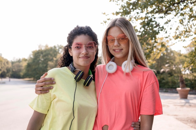 Chicas de tiro medio con auriculares posando
