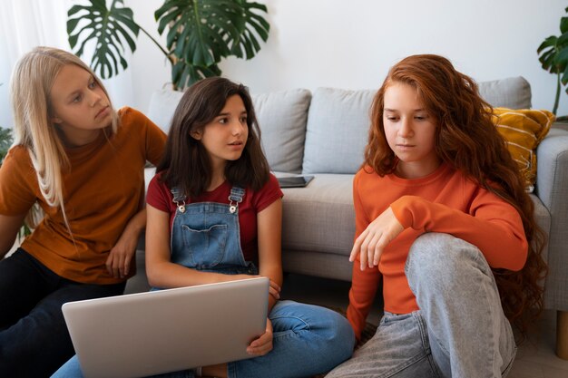 Chicas de tiro medio criticando a un amigo.