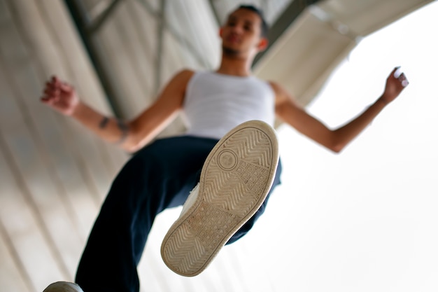 Foto gratuita chico de ángulo bajo haciendo parkour