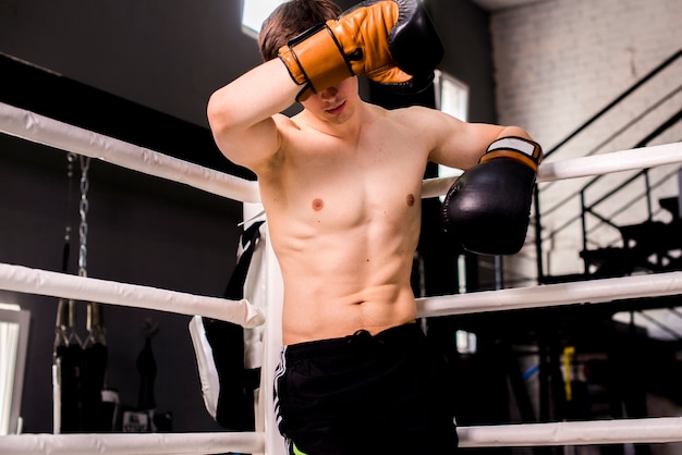 Foto gratuita chico boxeador posando en el gimnasio