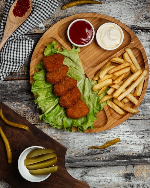 Foto gratuita chig kogte turco en lechuga con papas fritas y salsas.