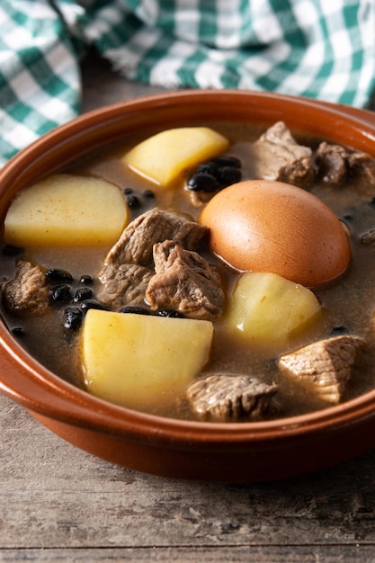 Foto gratuita cholent judío tradicional en tazón sobre mesa de madera