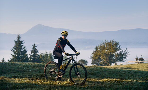 Ciclista masculino montando bicicleta en las montañas