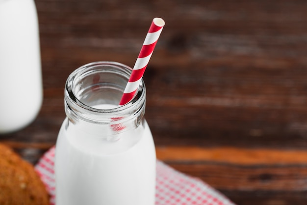 Ciérrese encima de la botella de leche con la paja