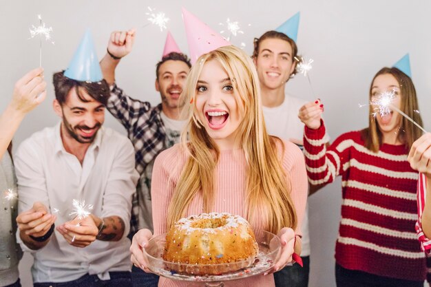 Cinco amigos con tarta de cumpleaños