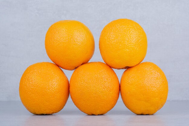 Cinco naranjas deliciosas enteras sobre fondo blanco. Foto de alta calidad