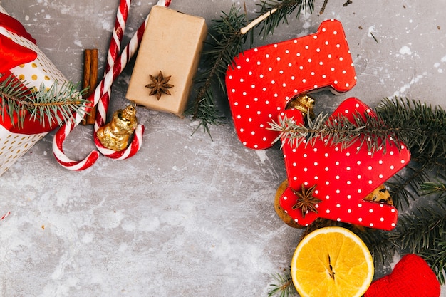 Círculo hecho de naranjas, galletas, ramas de abeto, cajas rojas presentes y otros tipos de decoración de Navidad