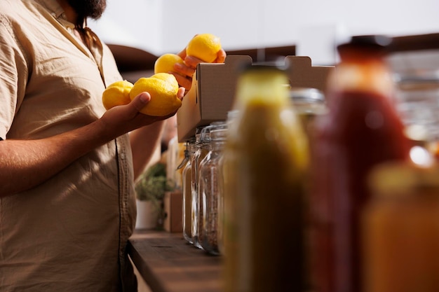 Foto gratuita cliente que compra limones frescos cultivados por un empresario de tienda sin desperdicio en su jardín. cliente vegano feliz de encontrar conservantes ecológicos frutas recién cosechadas libres en la tienda local, cerrar